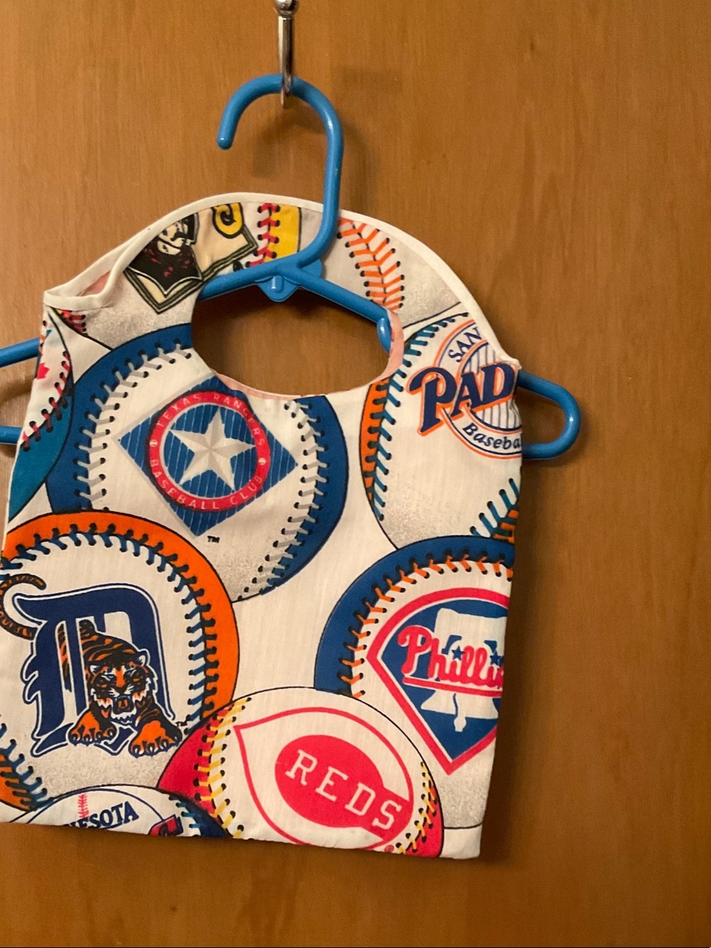 White Kids Bib with Blue and Orange Sports Circle Logos